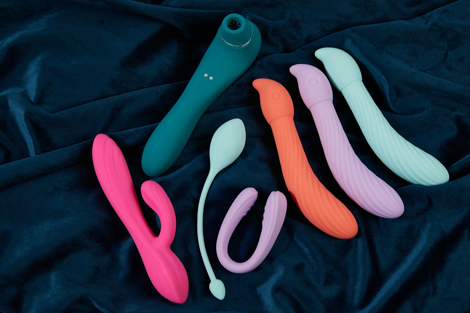 Colorful vibrators and intimate wellness toys displayed on a bright yellow background