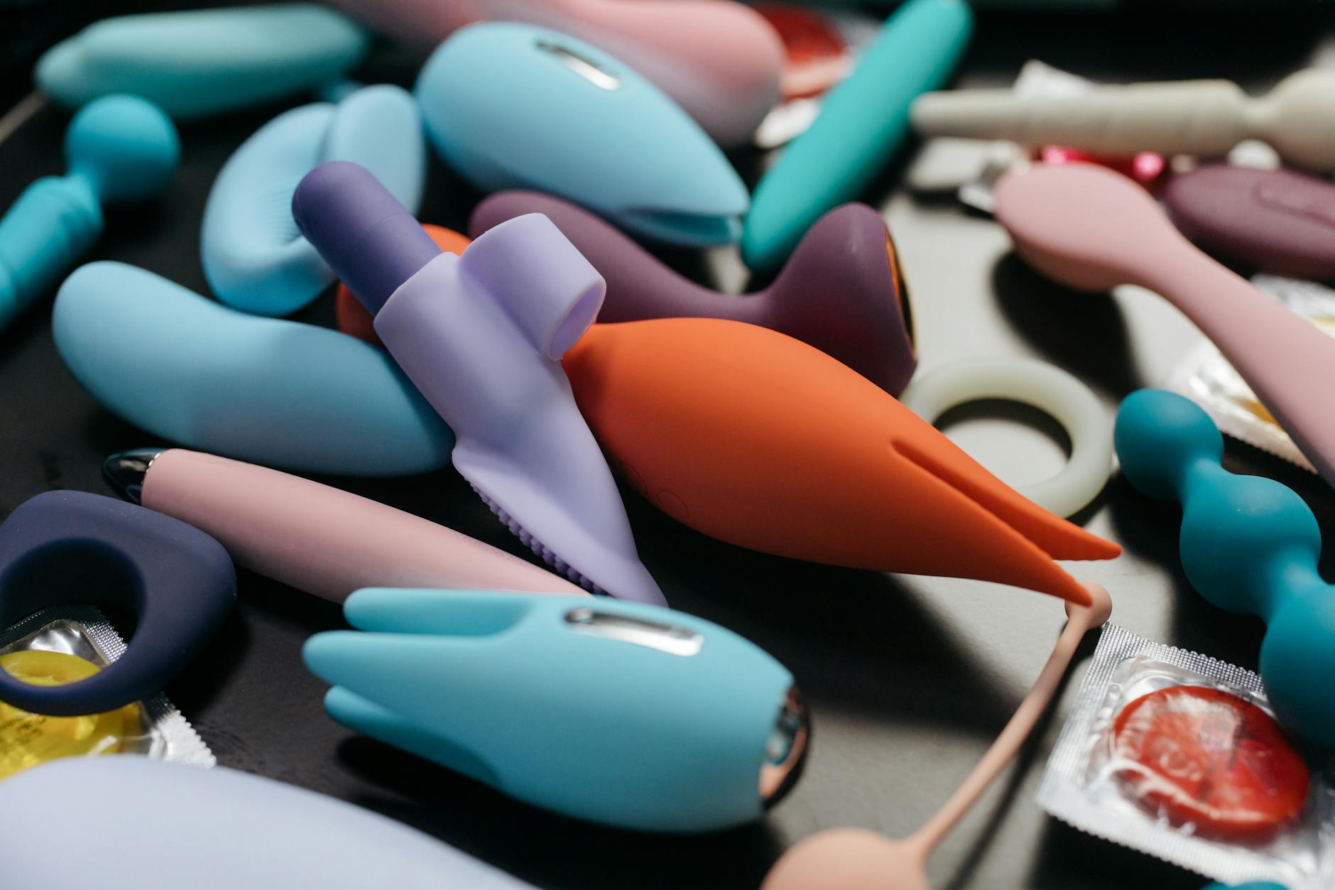 Close-up of a hand holding a pink vibrator, emphasizing intimate self-care and pleasure