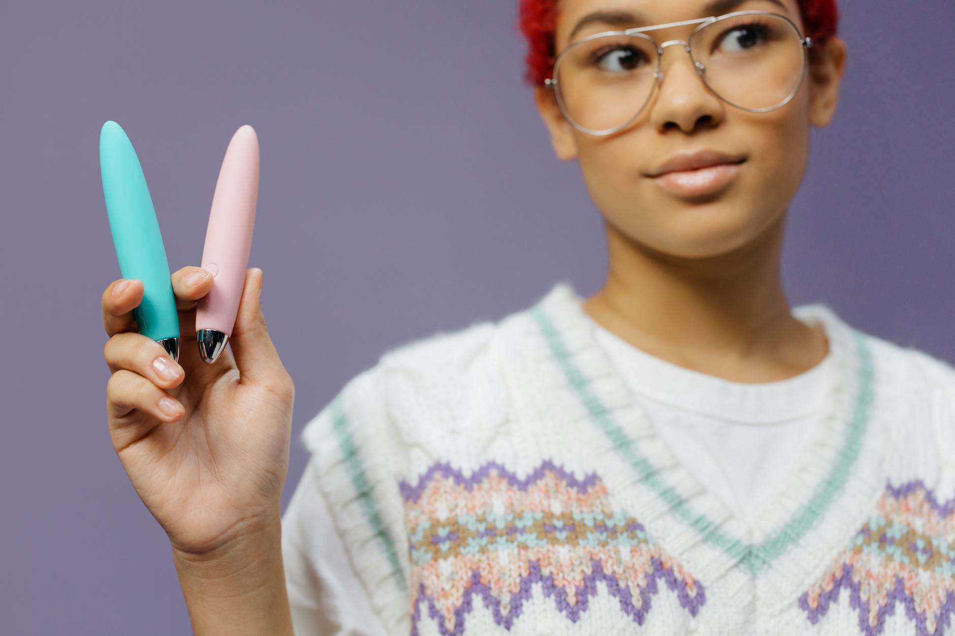 Woman holding a blue vibrator and considering her pleasure options