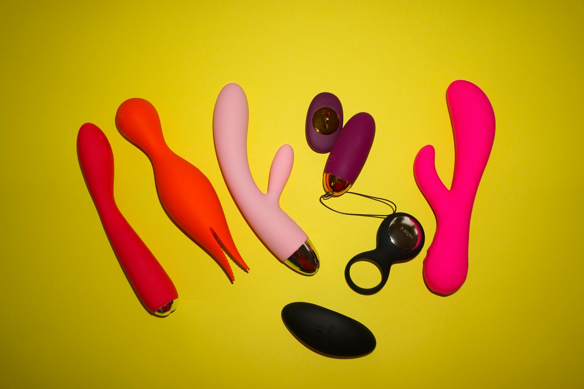 A person holding a basket containing colorful lemon vibrators and adult toys